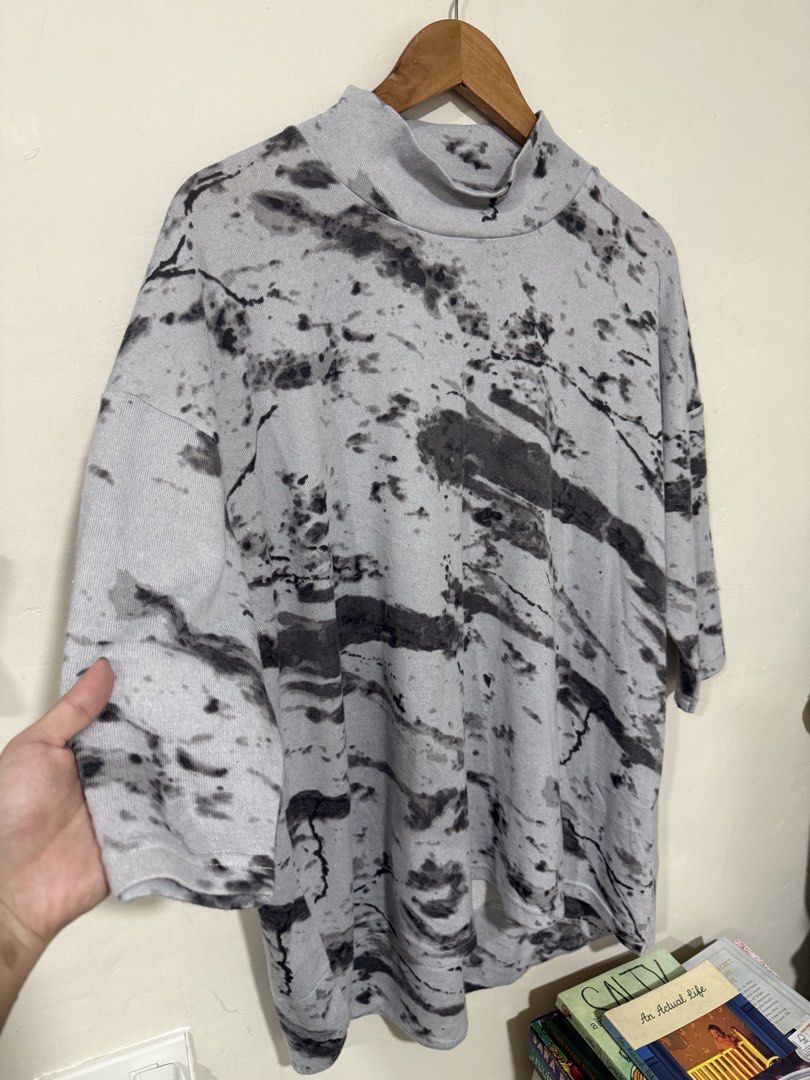 Marks & Spencer Comfy Blouse (Category: Blouses) located in Manila. Submitted by morningthrifters (Listing ID 1466105867, Image 3). Description: Marks & Spencer The selected item is an oversized, grey and black marble/tie-dye print top featuring drop shoulders and a high funnel or mock neckline. While Marks & Spencer regularly releases popular tie-dye collections, this specific oversized mock-neck silhouette with an all-over fluid, marbled abstra