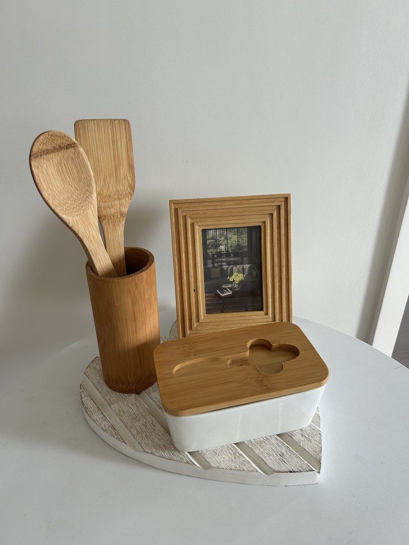Matching kitchen and home decor set (Category: Dinnerware & Cutlery) located in Quezon City. Submitted by curatedfindsy (Listing ID 1465984972, Image 1). Description: Selling everything together as a set TAKE ALL ₱350 Inclusions: Wooden utensils in a holder, butter dish with wooden lid, small wooden photo frame, and white heart-shaped wooden tray. Minimalist look for countertops and dining tables. 📍Quezon City .