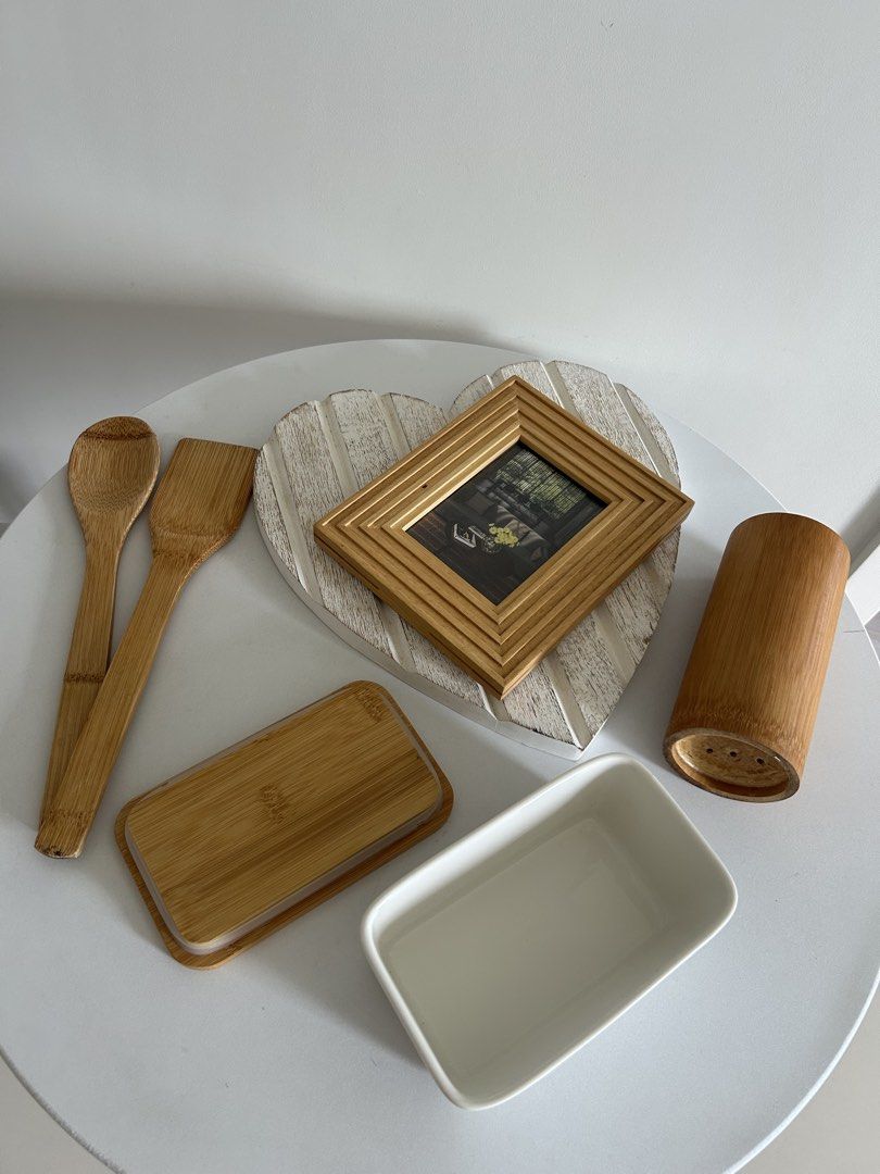 Matching kitchen and home decor set (Category: Dinnerware & Cutlery) located in Quezon City. Submitted by curatedfindsy (Listing ID 1465984972, Image 3). Description: Selling everything together as a set TAKE ALL ₱350 Inclusions: Wooden utensils in a holder, butter dish with wooden lid, small wooden photo frame, and white heart-shaped wooden tray. Minimalist look for countertops and dining tables. 📍Quezon City .