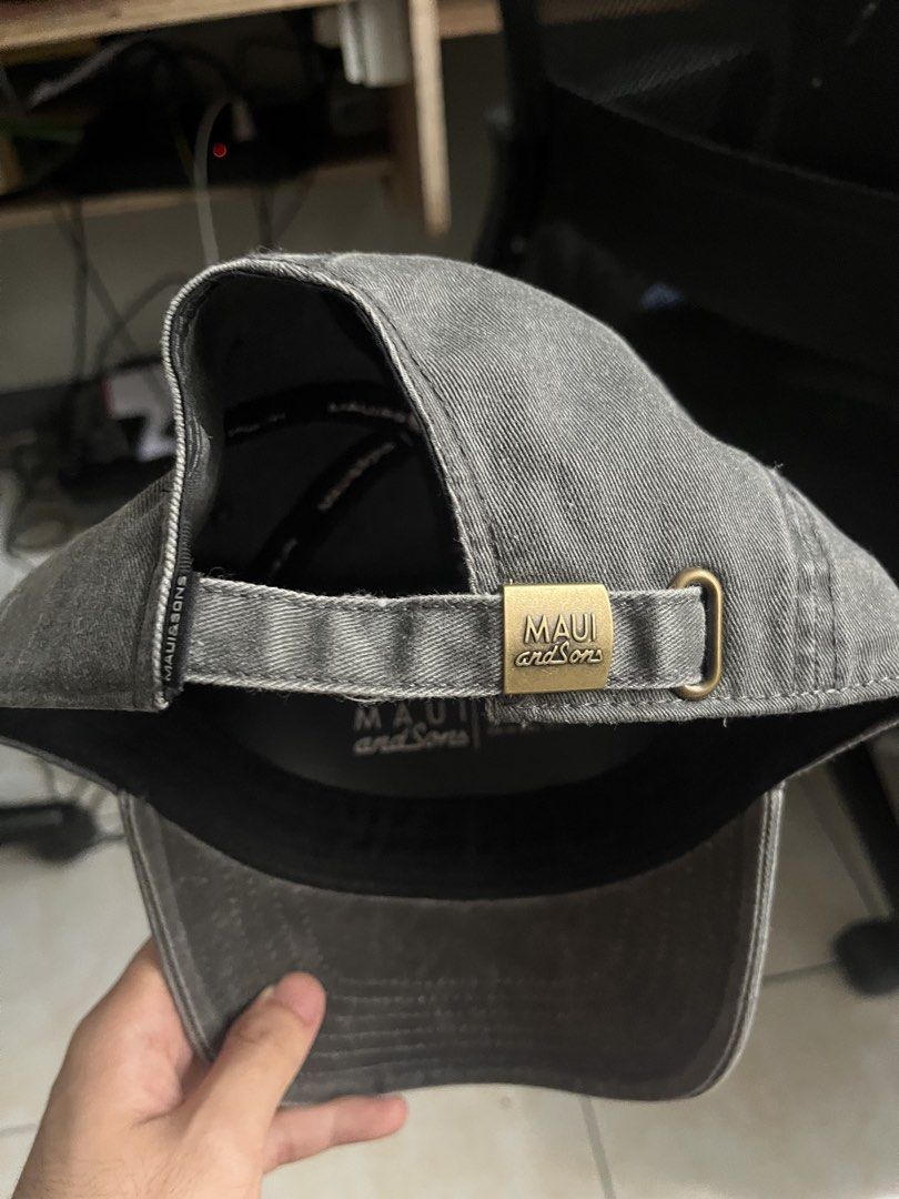Maui and Sons Grey Dad Cap (Category: Caps & Hats) located in Malabon City. Submitted by sukehirou (Listing ID 1465966928, Image 2). Description: - Brand: Maui and Sons - Color: Washed grey - Material: 100% cotton - Design: Embroidered blue logo on front - Details: Adjustable strapback with branded metal buckle, 'Ride Your Life' inner taped seams - Condition: Brand new, never worn RFS: declutterring.