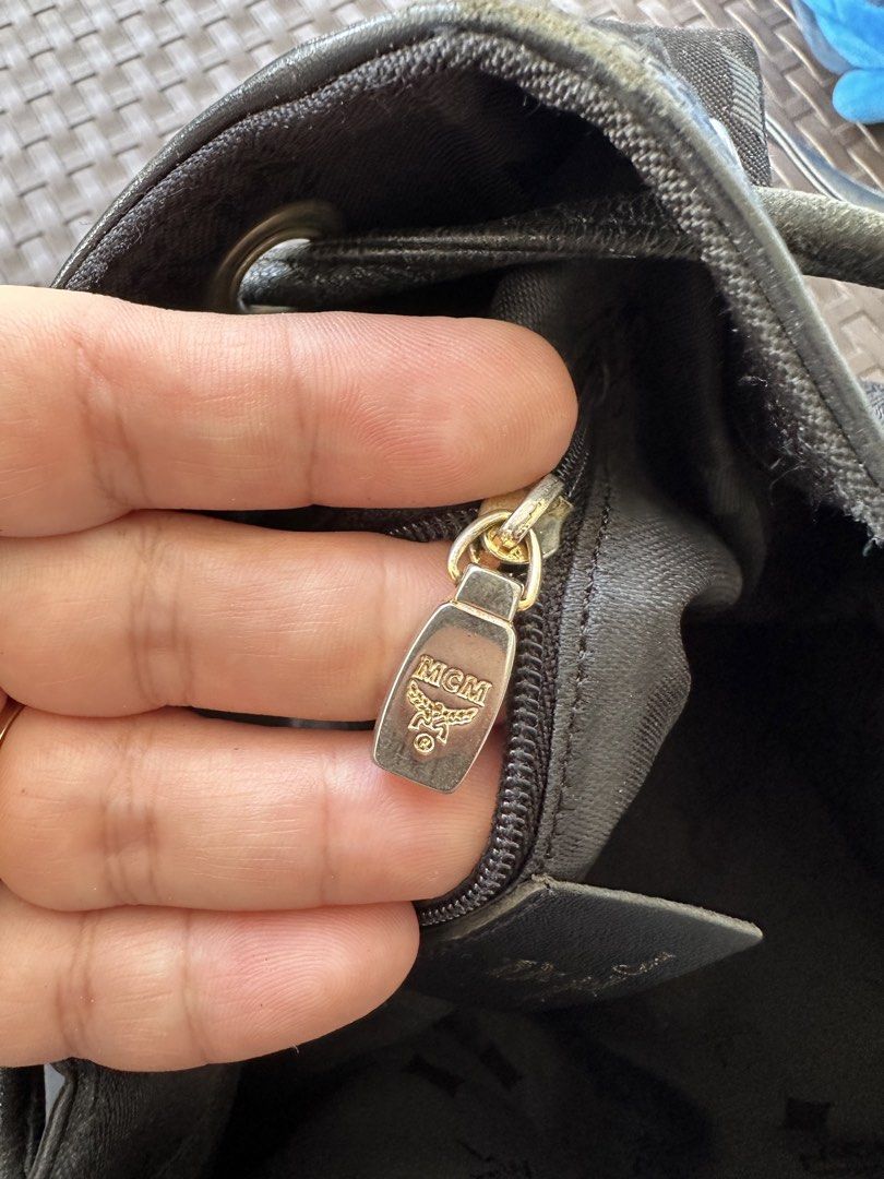 MCM Black Monogram Canvas Bucket Bag (Category: Luxury Bags & Wallets) located in San Pablo. Submitted by angiemac0921 (Listing ID 1465979127, Image 3). Description: - Authentic Black MCM bucket bag with iconic all-over monogram pattern - Secure drawstring closure with stylish knotted detail - Versatile adjustable shoulder strap for easy crossbody or shoulder wear - Sleek silver-tone hardware accents - Interior zip pocket with signature MCM logo 