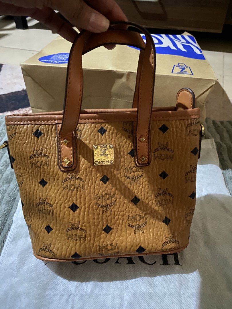 MCM Visetos Monogram Designer Handbag Collection (Category: Luxury Bags & Wallets) located in Muntinlupa City. Submitted by prettythess (Listing ID 1466155200, Image 3). Description: - Iconic MCM monogram print with luxurious brown pebbled leather texture - Elegant gold-tone hardware details - Multiple styles available: shoulder bags, mini bowling bags, and tote bags - Select designs feature playful rabbit patches - Spacious interiors ideal for d