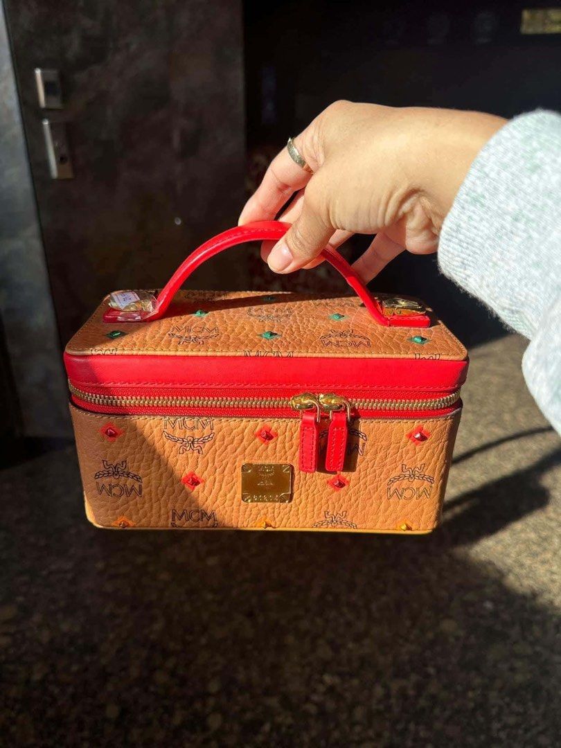 MCM Visetos Monogram Vanity Case Bag Red (Category: Luxury Bags & Wallets) located in Davao. Submitted by triftedbagsforyou (Listing ID 1466046333, Image 2). Description: - Brand: MCM Vanity Case - Colorway: Classic cognac visetos monogram with vibrant red leather trim - Hardware: Premium gold-tone hardware - Straps: Includes 2 interchangeable straps (matching leather strap and wide red fabric logo strap) - Closure: Secure dual zip closure with a