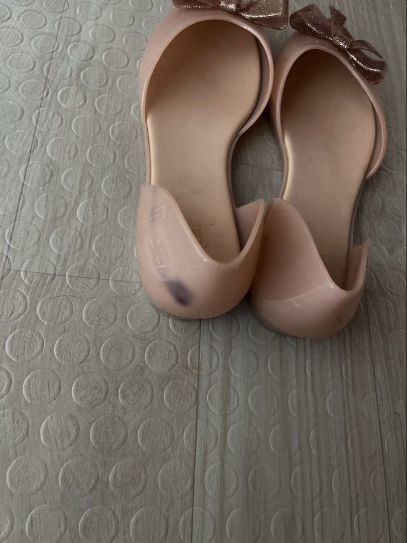 Melissa Pink Jelly Flats with Glitter Bow (Category: Flats & Sandals) located in Quezon City. Submitted by altheakatecollection (Listing ID 1465991219, Image 3). Description: - Brand: Melissa - Color: Light pink with a glittery front bow - Style: Cutout sides, pointed toe, flat rubber design - Features: Signature Melissa scented insoles, easy to wipe clean - Condition: Good, with a minor dark scuff mark on the back heel of the left shoe - Perfect