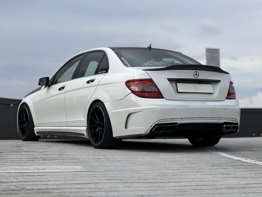 Mercedes-Benz C-Class Saloon C180 Kompressor (A) (Category: Used Cars) located in Singapore. Submitted by districtxdreams (Listing ID 1466148092, Image 2). Description: White exterior body paired with a carbon fiber hood and black roof accents. Black leather interior seats throughout the cabin. Upgraded infotainment display mounted on the center dash console alongside custom carbon fiber trim pieces. Custom steering wheel wrapped in black leather