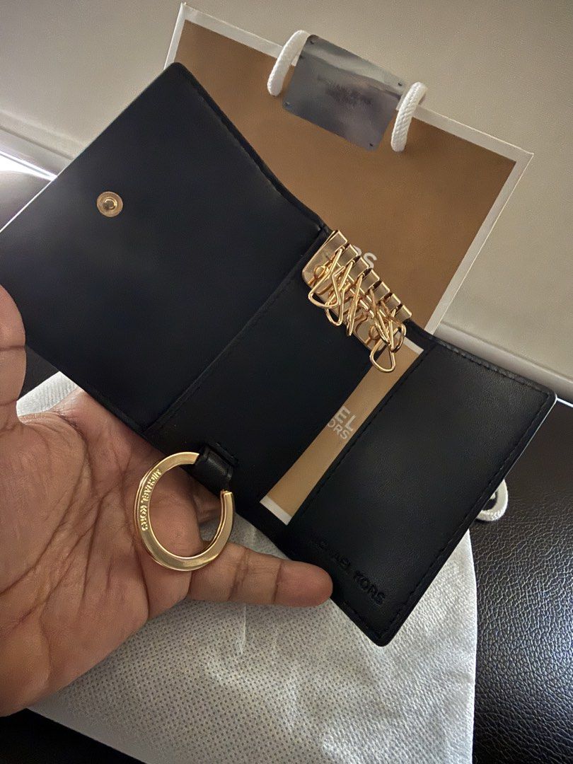 Michael Kors Black Leather Key Case (Category: Wallets & Card holders) located in Makati City. Submitted by trixortreat (Listing ID 1465957786, Image 2). Description: - Authentic Michael Kors key case - Premium black pebble leather with gold-tone hardware - Secure snap button closure - Multiple interior key hooks and a detachable ring included - Comes with original dust bag and paper gift bag - RFS: appreciated gift but I already have too many wa