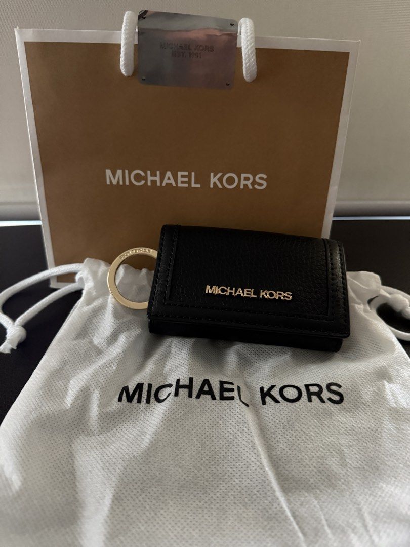 Michael Kors Black Leather Key Case (Category: Wallets & Card holders) located in Makati City. Submitted by trixortreat (Listing ID 1465957786, Image 1). Description: - Authentic Michael Kors key case - Premium black pebble leather with gold-tone hardware - Secure snap button closure - Multiple interior key hooks and a detachable ring included - Comes with original dust bag and paper gift bag - RFS: appreciated gift but I already have too many wa