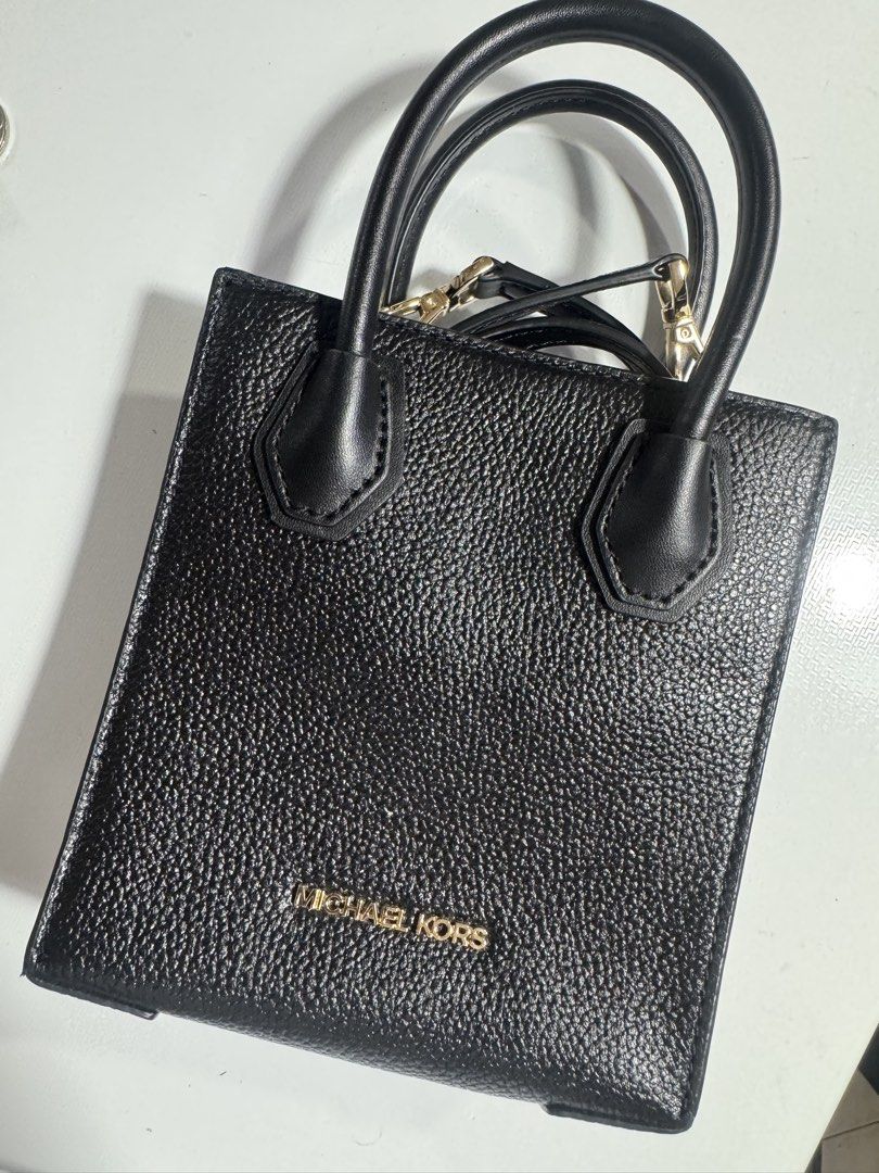 Michael Kors Black Leather Mini Tote Bag (Category: Luxury Bags & Wallets) located in Manila. Submitted by ashsieoo (Listing ID 1466115691, Image 1). Description: - Brand: Michael Kors - Material: Premium black pebbled leather - Hardware: Elegant gold lettering logo and accents - Design: Clean, structured mini tote with minimalist style - Versatility: Goes with everything, perfect for daily use - Straps: Double top handles and an included adjusta