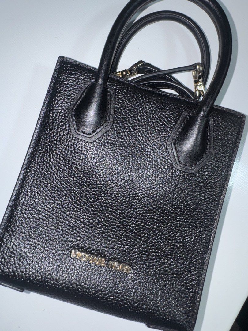 Michael Kors Black Leather Mini Tote Bag (Category: Luxury Bags & Wallets) located in Manila. Submitted by ashsieoo (Listing ID 1466115691, Image 2). Description: - Brand: Michael Kors - Material: Premium black pebbled leather - Hardware: Elegant gold lettering logo and accents - Design: Clean, structured mini tote with minimalist style - Versatility: Goes with everything, perfect for daily use - Straps: Double top handles and an included adjusta
