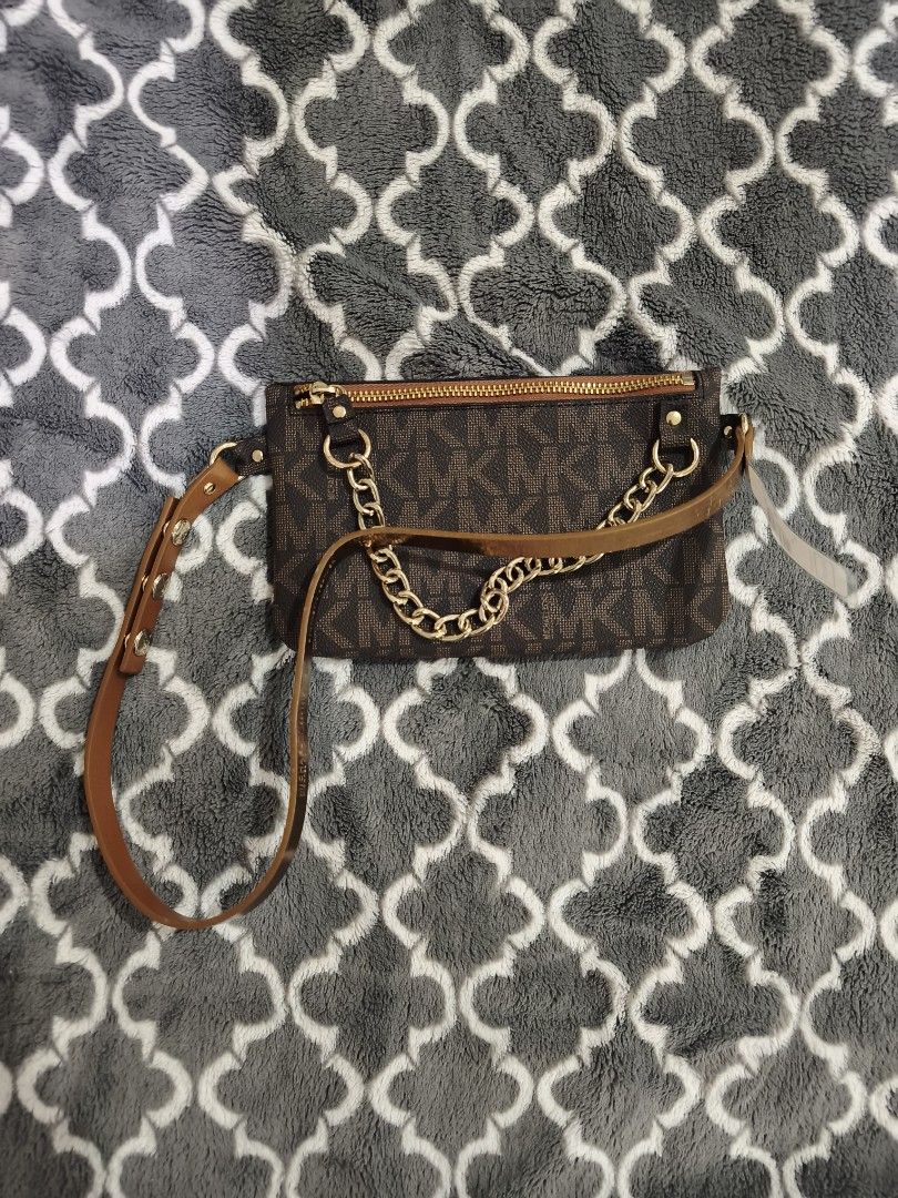 Michael Kors Brown MK Monogram Wristlet Clutch (Category: Luxury Bags & Wallets) located in Manila. Submitted by krisellerxoxo (Listing ID 1466155239, Image 1). Description: - Brand new, never used with original $55 store tag still attached - Classic brown Michael Kors monogram print with gold-tone hardware - Secure top zipper closure with an attached matching brown wrist strap - Chic gold decorative chain detail across the front - Pristine and c