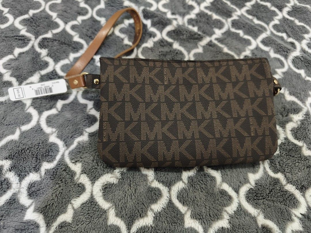 Michael Kors Brown MK Monogram Wristlet Clutch (Category: Luxury Bags & Wallets) located in Manila. Submitted by krisellerxoxo (Listing ID 1466155239, Image 2). Description: - Brand new, never used with original $55 store tag still attached - Classic brown Michael Kors monogram print with gold-tone hardware - Secure top zipper closure with an attached matching brown wrist strap - Chic gold decorative chain detail across the front - Pristine and c