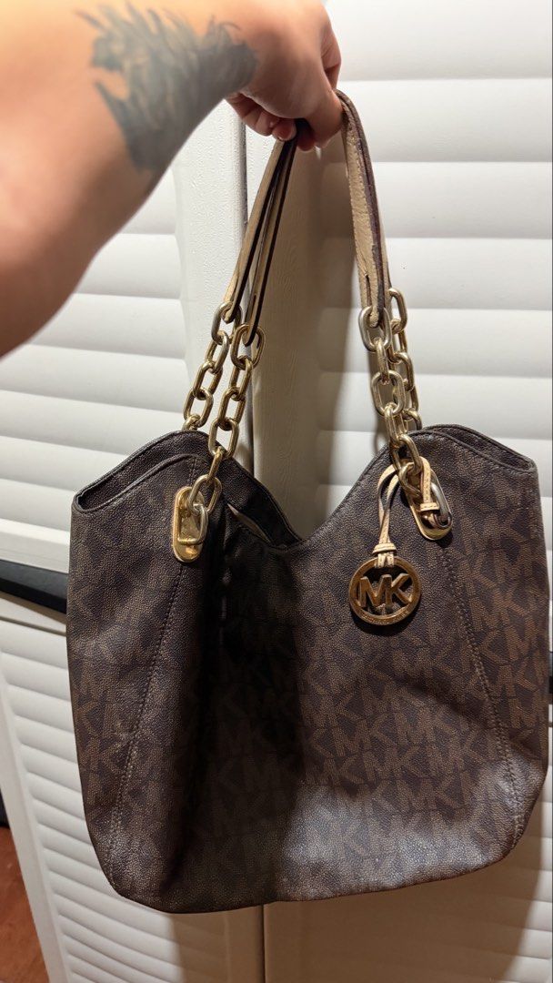 Michael Kors Brown Monogram Shoulder Bag with Chain Straps (Category: Luxury Bags & Wallets) located in Manila. Submitted by swiftdragon.6d8469 (Listing ID 1466064523, Image 1). Description: - Michael Kors brown monogram shoulder bag - Natural wear on the light leather strap handles from regular use -neg.