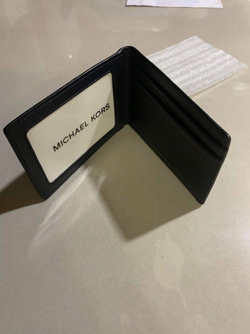 Michael Kors Leather Bifold Wallet Blue (Category: Luxury Bags & Wallets) located in Manila. Submitted by delmundoem21114 (Listing ID 1465962505, Image 1). Description: - Authentic Michael Kors men's bifold wallet - Color: Navy blue with silver embossed logo - Material: Premium textured leather with clean stitching - Slim profile designed to fit easily in pockets - Interior features multiple card slots, slip pockets, and a clear ID window.