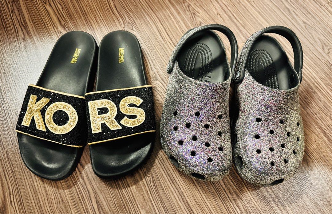 Michael Kors Slides and Glitter Crocs Bundle (Category: Flats & Sandals) located in Quezon City. Submitted by rhonadc (Listing ID 1465954313, Image 1). Description: Size W9 - Bundle deal: 2 pairs of easy slip-on shoes for your daily rotation - Pair 1: Michael Kors black slides featuring stylish gold glitter lettering across the strap - Pair 2: Grey glitter clogs equipped with secure heel straps and breathable ventilation holes - Condition: Normal