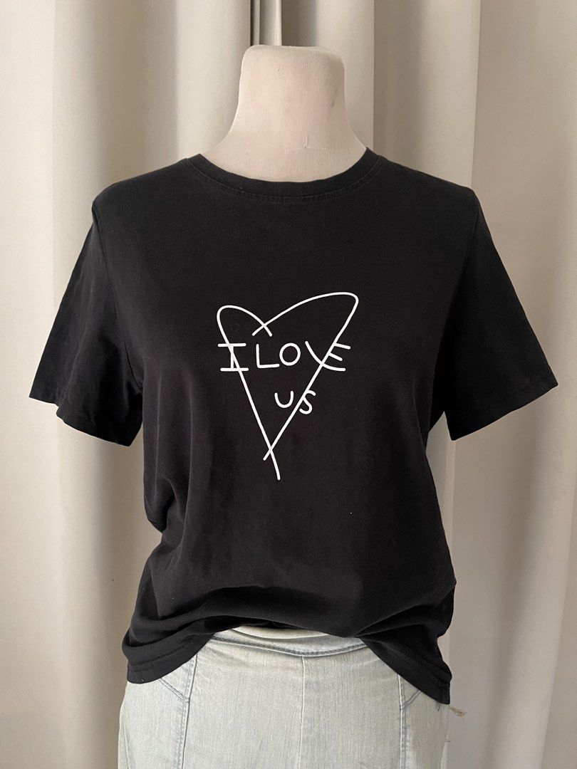 minimalist black (Category: Shirts) located in Cainta. Submitted by zlove111 (Listing ID 1466110251, Image 1). Description: - Color: Black - Design: White heart graphic with "I Love Us" text on chest - Fit: Relaxed fit with crew neckline - Material: Soft and comfortable cotton - Versatile: Great for pairing with denim jeans or shorts for everyday wear large no issue .