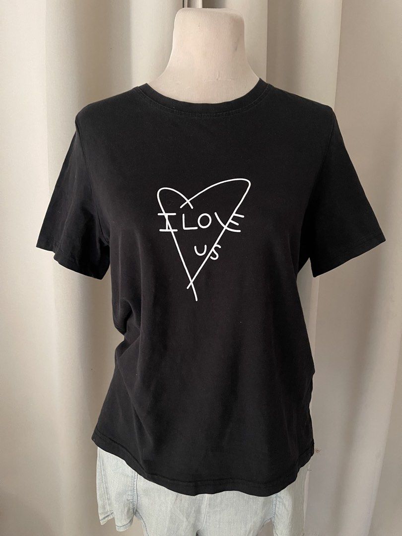 minimalist black (Category: Shirts) located in Cainta. Submitted by zlove111 (Listing ID 1466110251, Image 2). Description: - Color: Black - Design: White heart graphic with "I Love Us" text on chest - Fit: Relaxed fit with crew neckline - Material: Soft and comfortable cotton - Versatile: Great for pairing with denim jeans or shorts for everyday wear large no issue .