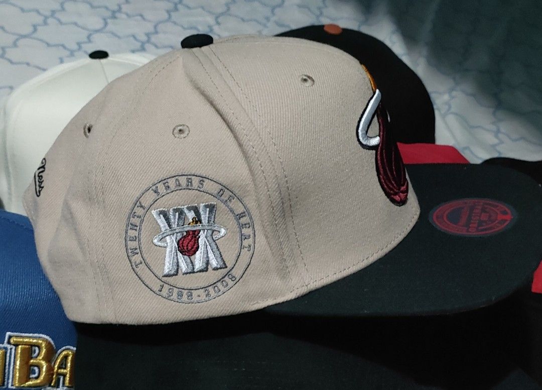 Mitchell & Ness Miami Heat Snapback Hat (Category: Caps & Hats) located in Manila. Submitted by acdouble-r (Listing ID 1466073804, Image 2). Description: Mitchell & Ness snapback cap, Miami Heat team logo embroidered front. Tan crown, black flat brim, black top button. Side embroidery marks twenty years of heat, 1988 to 2008. Original fit sticker placed on the brim. Clean stitching throughout..
