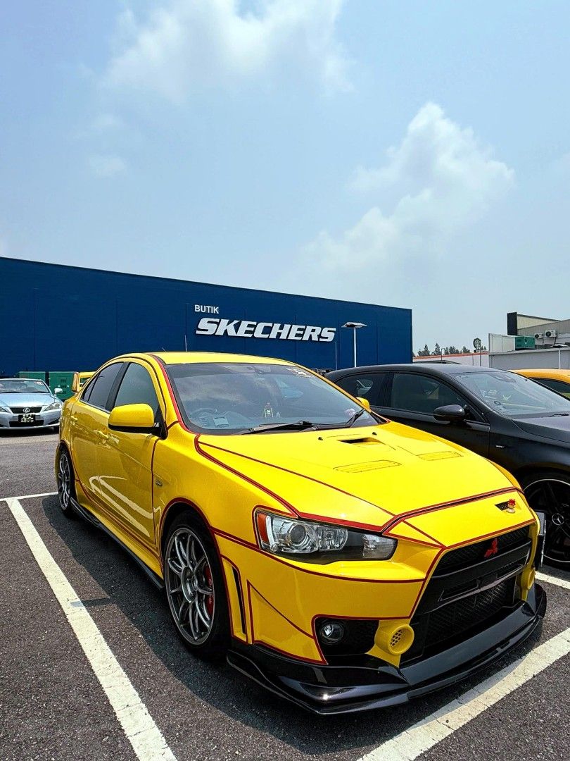 Mitsubishi Lancer EX 2.0 GT (A) (Category: Used Cars) located in Singapore. Submitted by zero_sgd (Listing ID 1466041027, Image 1). Description: Bright yellow Mitsubishi Lancer EX bodykit setup. Custom red panel pin-striping wrapping the front fascia and hood. Multi-spoke chrome alloy wheels, red brake calipers. Inside has black and red bucket seats. Hood vents installed. Clean paint finish overall. View to believe its conditions. List of mod don
