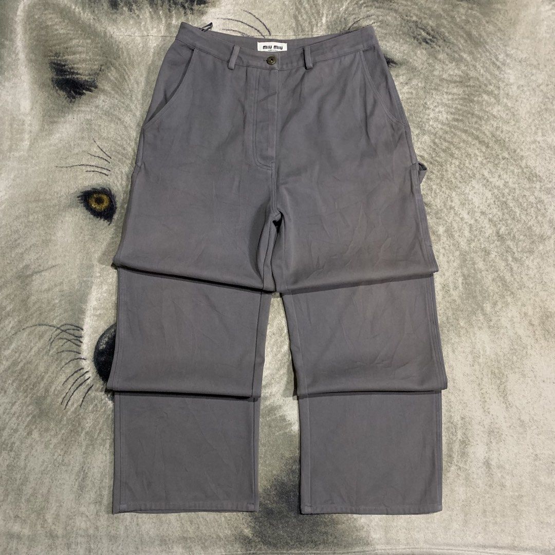 Miu Miu Grey Carpenter Pants Size 36 (Category: Trousers) located in Bulacan. Submitted by puronghustlin (Listing ID 1466114575, Image 3). Description: - Authentic Miu Miu cargo pants in solid grey - Made in Italy with branded hardware and button fly closure - Functional utility pockets featuring a side tool loop - Distinctive embroidered logo detail on the back pocket - Interior tags and size label completely intact - Premium designer streetwear