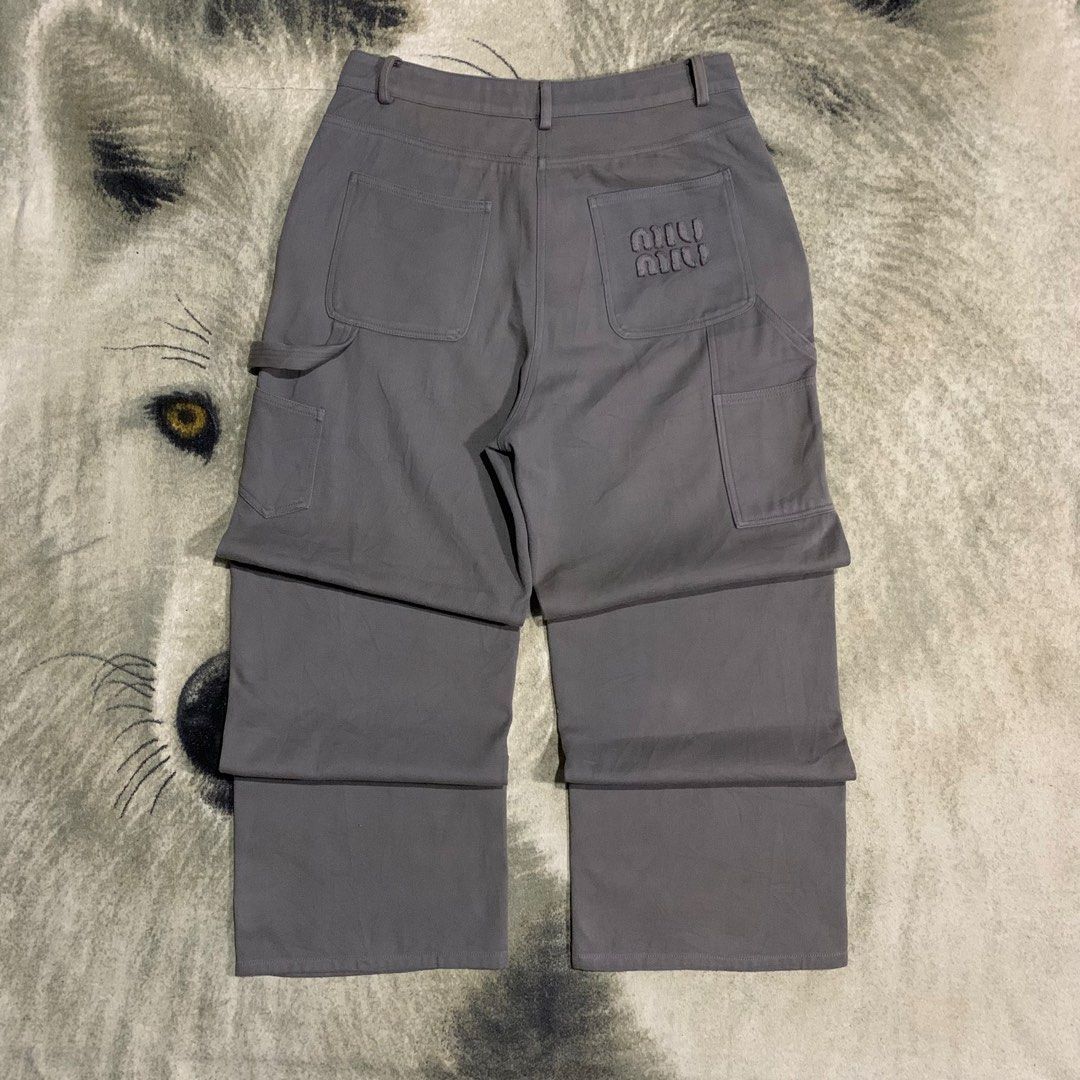 Miu Miu Grey Carpenter Pants Size 36 (Category: Trousers) located in Bulacan. Submitted by puronghustlin (Listing ID 1466114575, Image 1). Description: - Authentic Miu Miu cargo pants in solid grey - Made in Italy with branded hardware and button fly closure - Functional utility pockets featuring a side tool loop - Distinctive embroidered logo detail on the back pocket - Interior tags and size label completely intact - Premium designer streetwear
