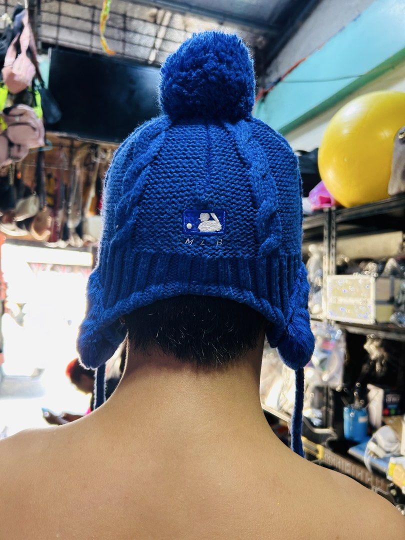MLB Los Angeles Dodgers Blue Earflap Beanie Hat (Category: Caps & Hats) located in Manila. Submitted by starbalesukandjapansurplus (Listing ID 1465960195, Image 3). Description: - Official MLB Los Angeles Dodgers branding with front logo and back batterman - Ultra-warm thick fleece lining for ultimate cold-weather comfort - Cute embroidered animal faces on the fuzzy earflaps - Fun braided chin straps with tassels and a playful top pom-pom - One s