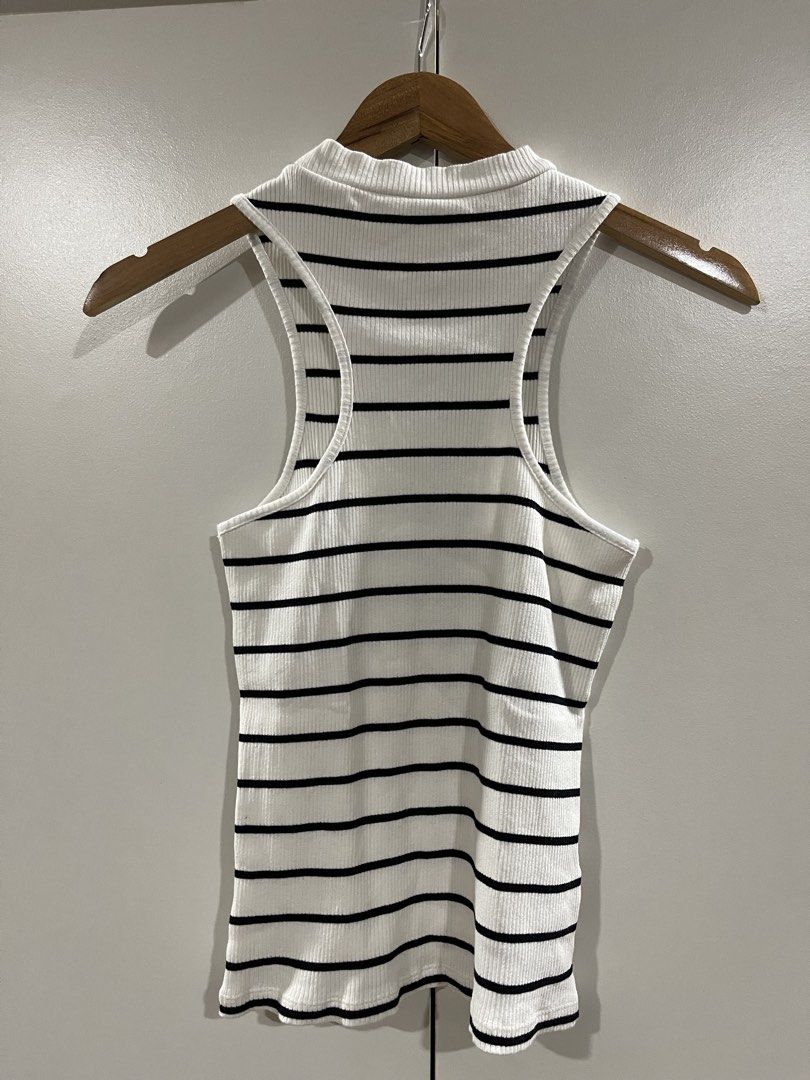 MNG Striped Ribbed Tank Top Medium (Category: Sleeveless) located in Quezon City. Submitted by minethenyours18 (Listing ID 1465957087, Image 3). Description: - Brand: MNG - Size: M - Design: White with black horizontal stripes - Cut: High neckline and racerback - Material: Stretchy, comfortable fabric - Style: Versatile basic, easy to match with jeans or skirts.