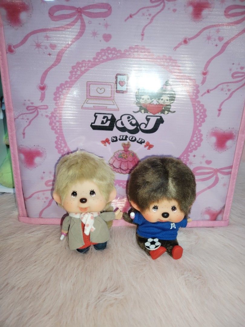 Monchhichi Doll Bundle Only (Category: Plushies & Soft Toys) located in Paombong. Submitted by eandj.shop (Listing ID 1466052648, Image 3). Description: 🎀 Set of 2 authentic Monchhichi plush dolls with super fluffy fur texture 🎀 Doll 1 outfit: Blonde hair, stylish grey coat, red shirt, polka dot scarf, and jeans 🎀 Doll 2 outfit: Brown hair, blue soccer jersey with letter 'M', red shoes, and includes a soccer ball accessory 🎀 Condition: Excell