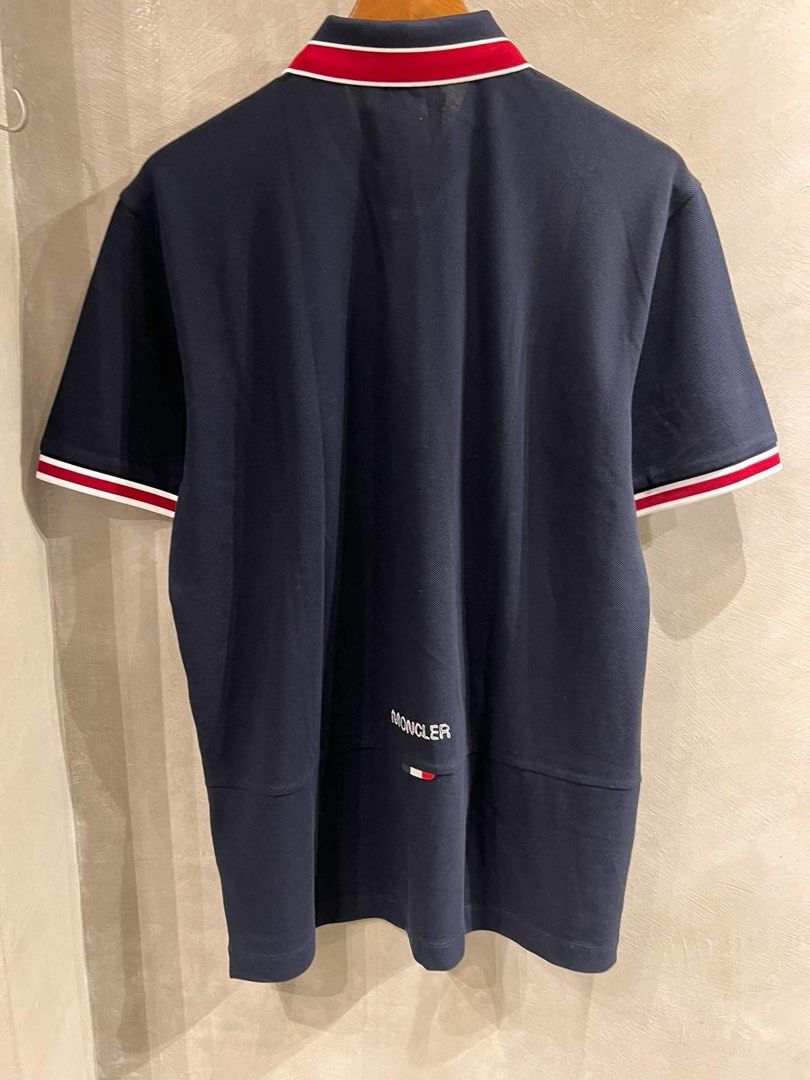 Moncler Pique Polo Shirt (Category: Tshirts & Polo Shirts ) located in Imus. Submitted by vdc.apparel (Listing ID 1465955880, Image 3). Description: Moncler Navy blue cotton piqué polo shirt tricolor red and white tipping accents on the collar and cuffs, along with the brand’s signature felt logo patch on the chest..