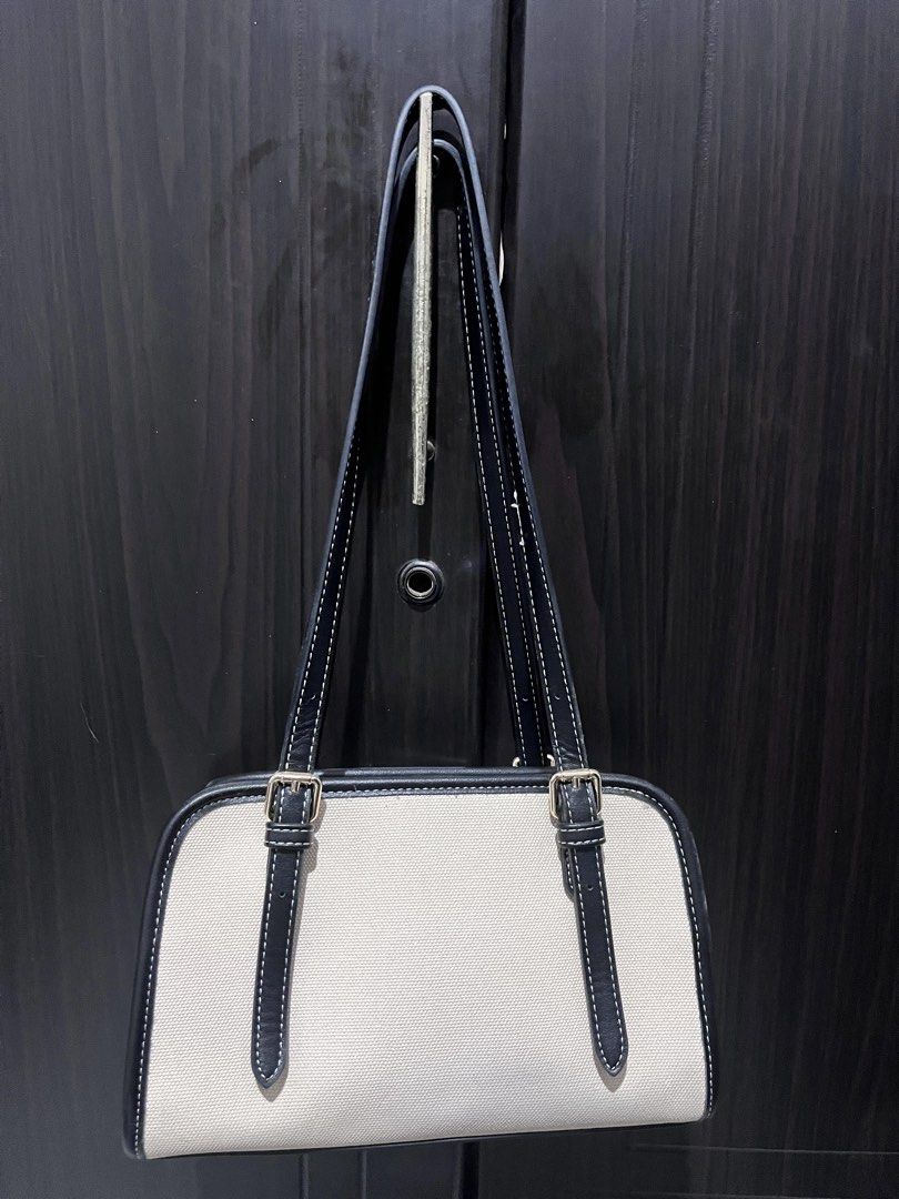 Mossdoom Canvas Shoulder Bag with Cherry Charm (Category: Shoulder Bags) located in Tarlac. Submitted by kylapam15 (Listing ID 1466040574, Image 2). Description: - Brand/Model: Mossdoom structured shoulder bag - Color/Material: Beige with Black - Design: Dual straps with trendy buckle accents on the front - Extra: Comes with a cute detachable metallic cherry keychain - Closure & Interior: Secure zipper top closure with a very clean interior and e