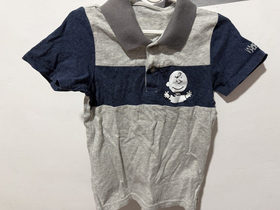 Mossimo Snoopy Peanuts Character Grey Blue Polo Shirt (Category: Tshirts & Polo Shirts ) located in Bocaue. Submitted by graceeshoppe (Listing ID 1466142984, Image 1). Description: - Brand: Mossimo - Design: Grey & dark blue colorblock with adorable embroidered Charlie Brown/Snoopy graphic - Details: Short sleeves, grey collar, button placket, brand tags on sleeve and inner collar - Material: Standard cotton blend (soft and comfy) - Style: Casual