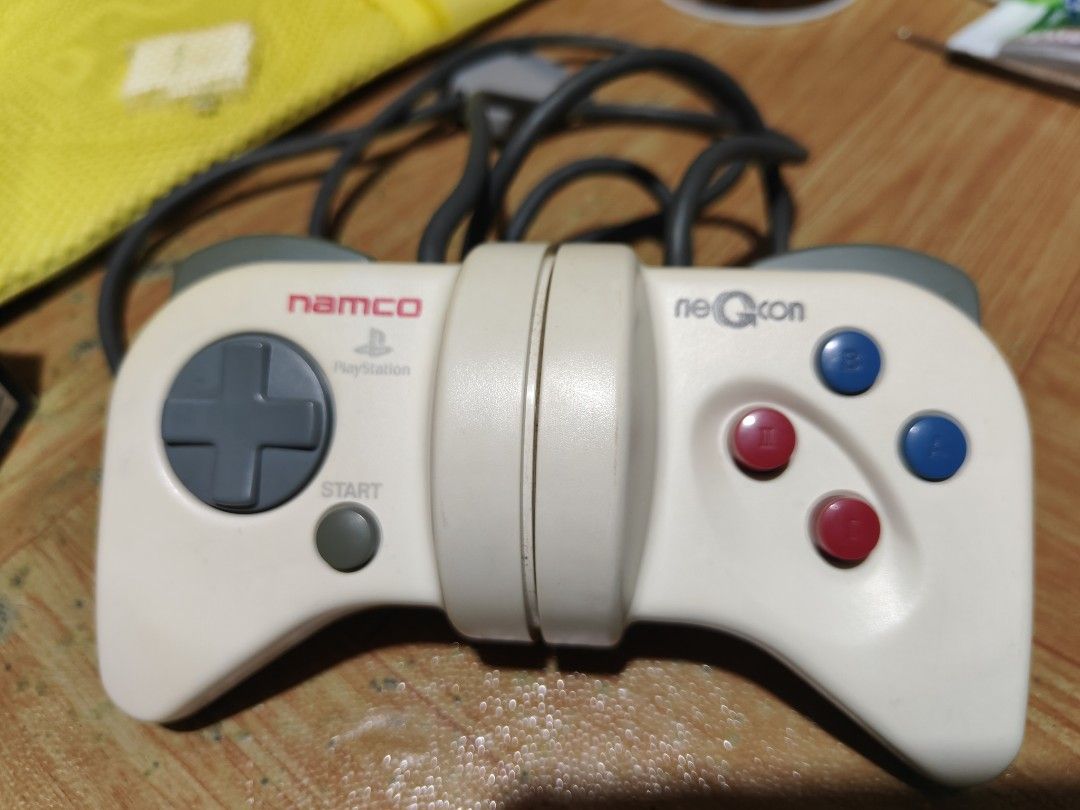 Namco neGcon PlayStation Controller NPC-101 with Box (Category: Controllers) located in Manila. Submitted by wuxue998 (Listing ID 1466054916, Image 2). Description: - Platform: Original PlayStation (PS1) - Model: NPC-101 (Made in Korea) - Design: Unique twisting body with D-pad, start button, and I, II, A, and B buttons - Condition: Controller in great working order; original box included with minor shelf wear and tear - Inclusions: Controller wi