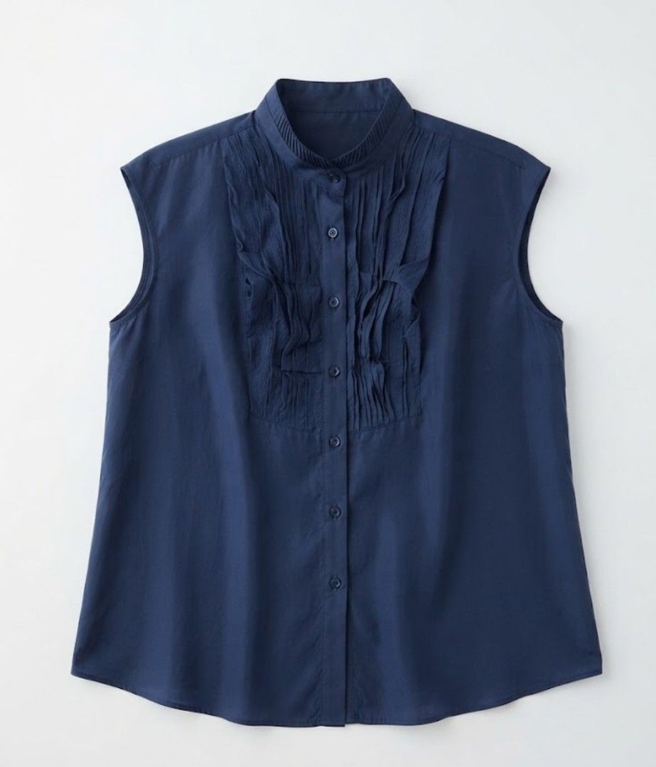 Navy Blue Sleeveless Ruffled High Collar linen Blouse (Category: Sleeveless) located in Donsol. Submitted by saksthriftavenuebyluckymaria8 (Listing ID 1466098034, Image 3). Description: - Color: Navy blue - Style: Sleeveless blouse with pleated front ruffles - Neckline: High mandarin collar with button-up closure - Fabric: Lightweight and comfortable - Versatility: Perfect for work or smart casual outings, easy to pair with trousers or skirts Che