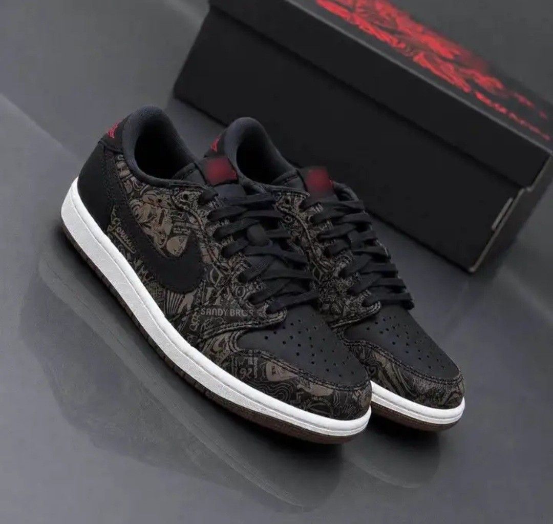 Nike Air Jordan 1 Low Og Laser (Category: Sneakers) located in Quezon City. Submitted by baksi11 (Listing ID 1465964514, Image 3). Description: - Brand: Nike Air Jordan 1 Low - Colorway: Black with unique tattoo and graffiti print panels - Details: Red Nike Air tongue branding and red heel wings logo - Soles: White midsole with black outsole - Condition: Brand new, never worn, pristine condition - Inclusions: Original black box and Jordan paper b