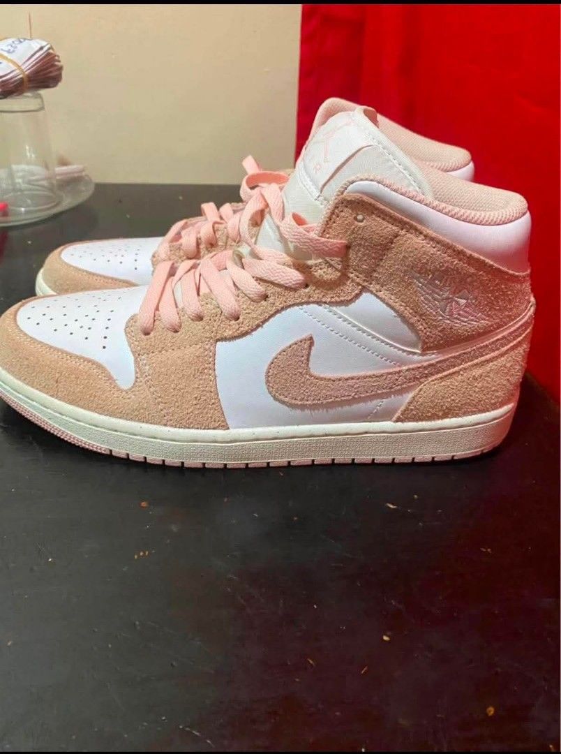 Nike Air Jordan 1 Mid Pink Suede (Category: Sneakers) located in Manila. Submitted by benta_ballz (Listing ID 1466146196, Image 2). Description: - Fresh from Dubai - Brand: Nike Air Jordan 1 Mid - Colorway: White and Peach Pink - Materials: Premium white leather base with textured peach pink suede overlays - Design details: Matching swooshes, laces, high-top collar, and iconic embossed wings logo - Soles: Clean white midsole paired with a durable