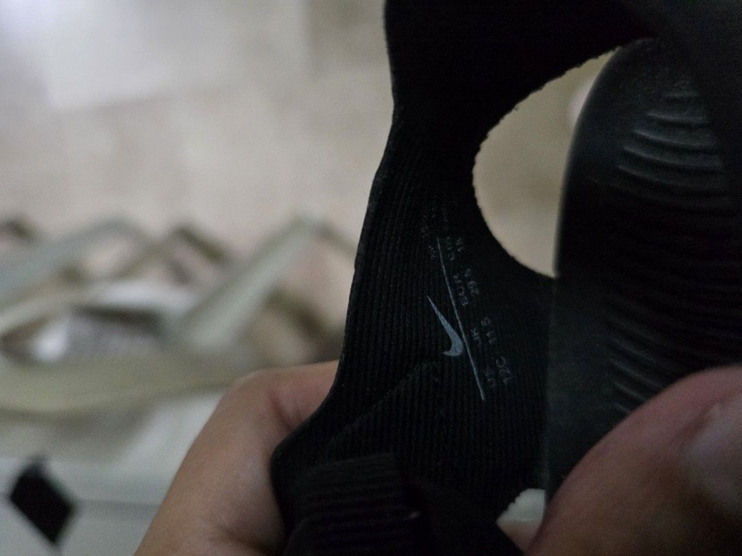 Nike Black Sandals Size US 12C (Category: Babies & Kids Fashion) located in Quezon City. Submitted by kbb.12345 (Listing ID 1466000989, Image 3). Description: - Brand: Nike - Color: Black with white Swoosh logo - Size: US 12C / UK 11.5 / EUR 29.5 - Style: Closed-toe sandals with ventilation holes for breathability - Closure: Adjustable velcro strap for a secure fit - Outsole: Textured wave pattern for reliable grip and traction - Condition: Fresh