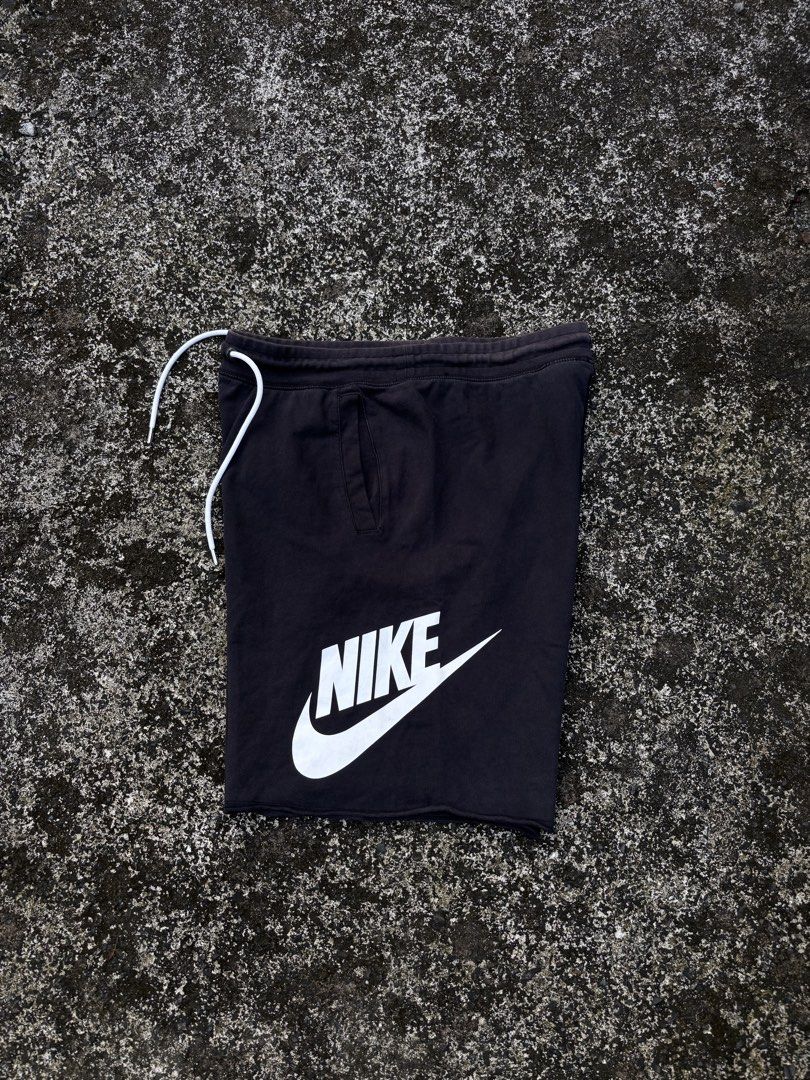 Nike Black Sweatshorts with White Logo Drawstring (Category: Shorts) located in Caloocan City. Submitted by elpotato (Listing ID 1466009724, Image 1). Description: - Brand: Nike - Item: Sweatshorts - Color: Black with bold white logo on lower leg - Material: Comfortable cotton fleece fabric - Fit: Regular fit with side pockets - Waistband: Drawstring with white cords - Condition: Shows mild fading around the waistband edges from washing and wear.