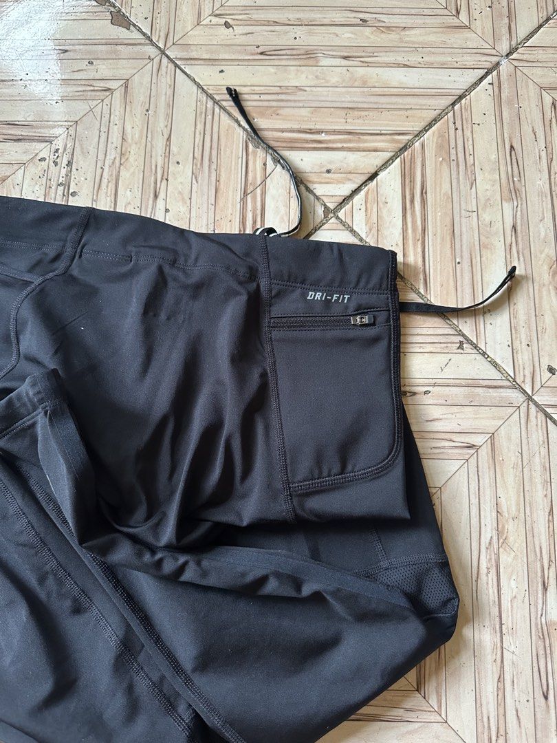 Nike Dri-FIT Men's Running Tights Black Size M (Category: Activewear) located in Angeles City. Submitted by alejeong27 (Listing ID 1466028021, Image 3). Description: - Brand: Nike - Item: Running Tights / Leggings - Color: Black - Size: Medium (M) - Condition: Excellent / Like New - Dri-FIT material wicks sweat to keep you dry - Adjustable drawstring waistband for a custom fit - Secure zippered pocket at the back waist for essentials - Mesh panel