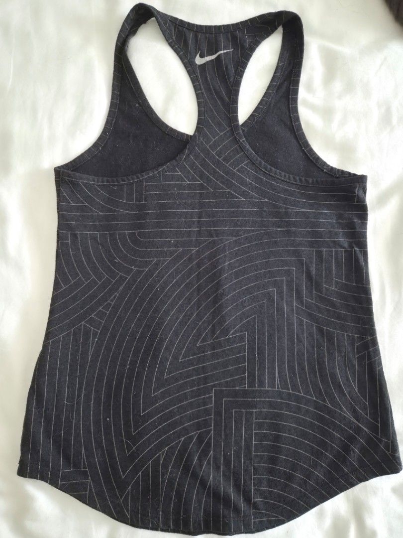 Nike Dri-FIT Run Graphic Tank Top (Category: Activewear) located in Quezon City. Submitted by corrnic (Listing ID 1465997834, Image 3). Description: - Brand: Nike - Style: Dri-FIT Racerback Tank Top - Size: S - Color: Black with geometric graphic lines - Details: Large white 'Run' logo on front, small Swoosh logo on the back - Material: Lightweight athletic fabric - Condition: Excellent / Great for gym workouts and running.