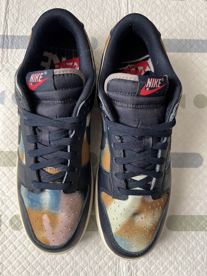 NIKE Dunk Low SE ‘Graffiti - Obsidian’ Size 10 (Category: Sneakers) located in Pasig City. Submitted by jenscloset86 (Listing ID 1465998509, Image 2). Description: Brand: NIKE Model: Nike Dunk Low SE ‘Graffiti - Obsidian’ Size: US 10 • No flaws, no damages. • Lightly used. • With box. - Nike Dunk Low sneakers - Unique tie-dye pattern on toe box and heel - Navy blue leather overlays - Classic Nike branding - Lace-up closure - Ideal for casual wear