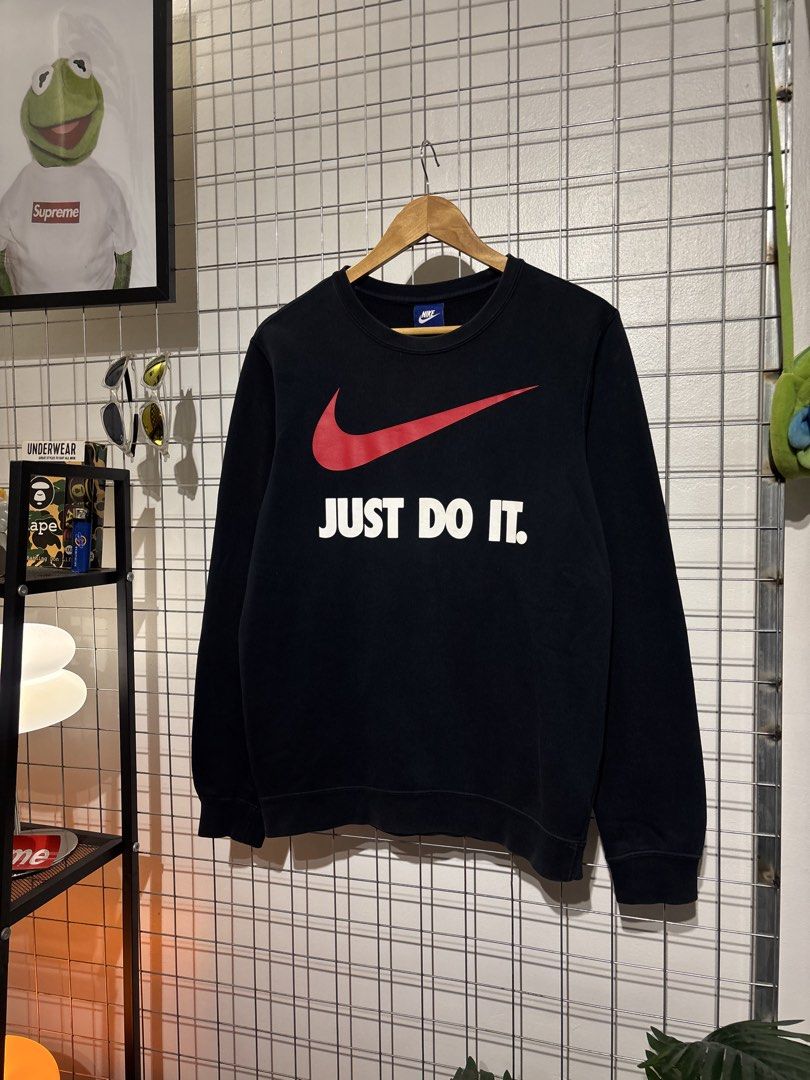 Nike Just Do It Black Sweatshirt Size M (Category: Coats, Jackets and Outerwear) located in Cavite. Submitted by vlblgrmnts_ (Listing ID 1466067994, Image 2). Description: Nike - P266 20x26 Bestfit meduim 9/10 CR 800 - Brand: Nike - Style: Sweatshirt / Pullover - Color: Black with large red swoosh and white 'Just Do It' text - Size: Medium (M) - Material: 80% cotton, 20% polyester - Condition: Clean, comfortable, great for daily wear - Origin: Ma