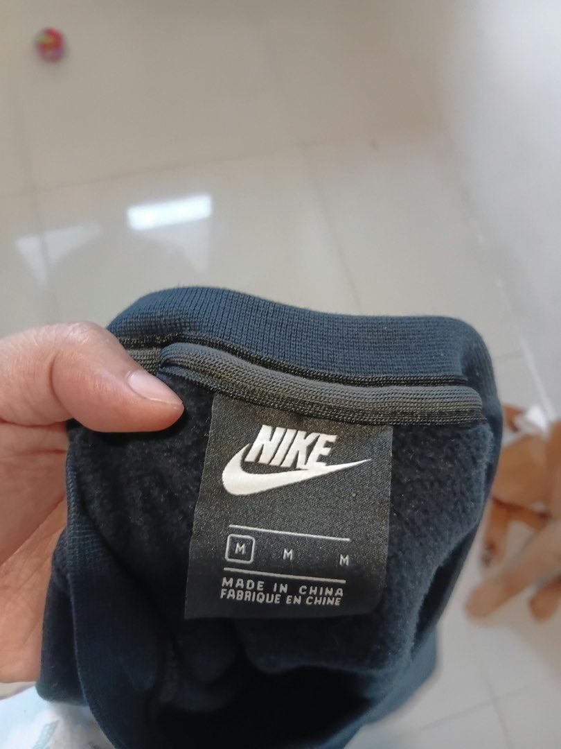 Nike Navy Blue Sweatshirt Size M (Category: Coats, Jackets and Outerwear) located in Antipolo. Submitted by wisecat.4a7eea (Listing ID 1466042933, Image 3). Description: - Brand: Nike - Style: Classic crewneck sweatshirt - Color: Solid black - Size: Medium (M) - Material: 80% cotton, 20% polyester blend - Features: Long sleeves, ribbed cuffs and hem, embroidered logo on collar tag - Condition: Clean exterior.