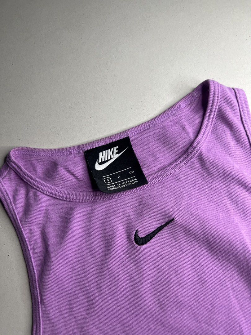 Nike Purple Ribbed Tank Top Size S (Category: Sleeveless) located in Tacloban City. Submitted by thrftg (Listing ID 1466114821, Image 2). Description: - Brand: Nike - Color: Purple with embroidered black swoosh logo - Material: Comfortable ribbed fabric - Size: Small - Design: Classic scoop neck - Condition: Excellent, clean with no stains or damage.