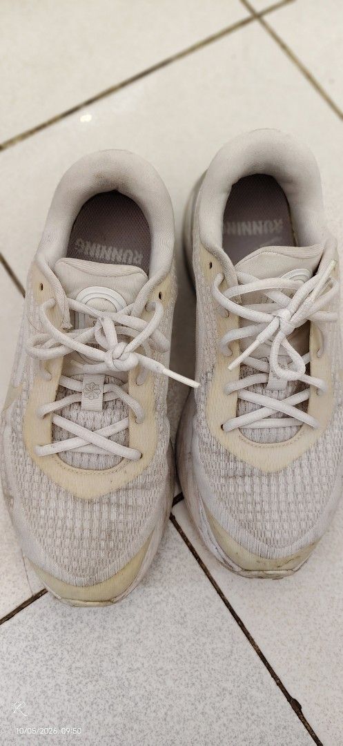 Nike Running Shoes White Silver (Category: Sneakers) located in Las Pinas. Submitted by Kariicature (Listing ID 1465965745, Image 2). Description: NEGOTIABLE - Brand: Nike running shoes - Color: White and silver with metallic midsole details - Material: Breathable mesh upper with lace-up fastening - Features: Small swoosh logo at the heel and printed branding on the interior sole - Condition: Signs of wear and yellowing on the fabric and soles na