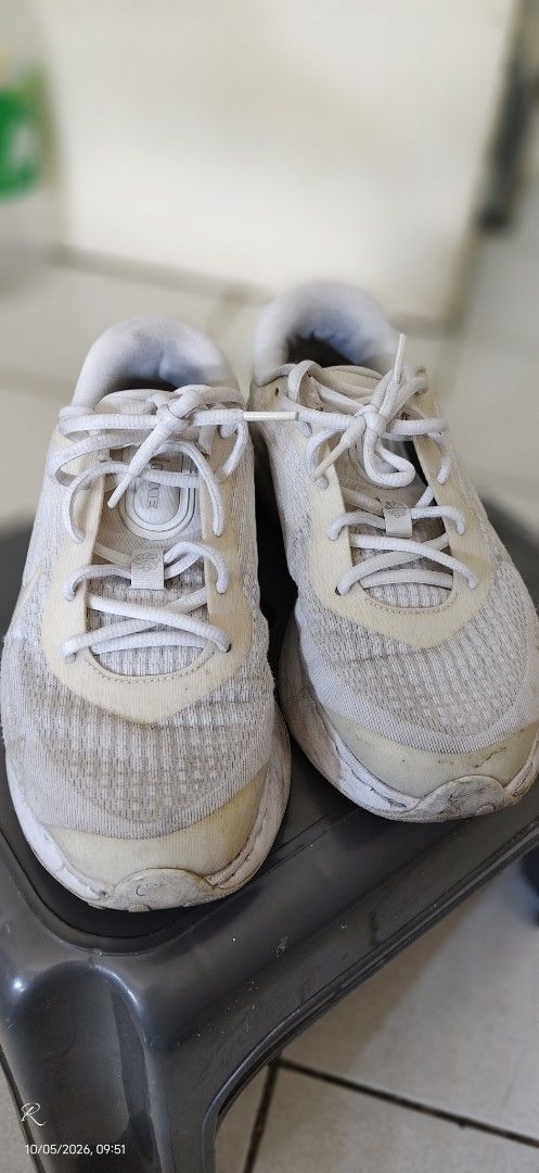 Nike Running Shoes White Silver (Category: Sneakers) located in Las Pinas. Submitted by Kariicature (Listing ID 1465965745, Image 3). Description: NEGOTIABLE - Brand: Nike running shoes - Color: White and silver with metallic midsole details - Material: Breathable mesh upper with lace-up fastening - Features: Small swoosh logo at the heel and printed branding on the interior sole - Condition: Signs of wear and yellowing on the fabric and soles na