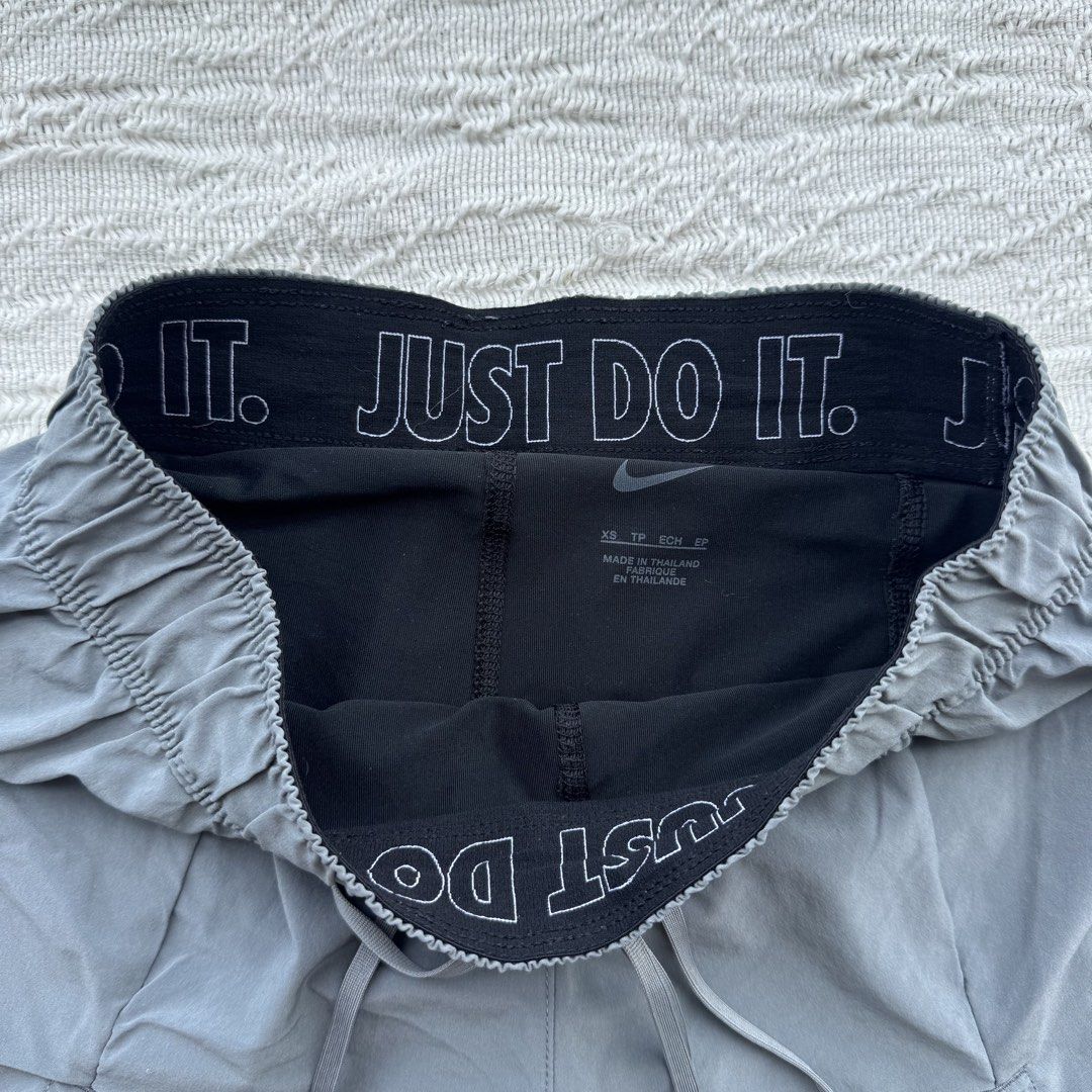 Nike Running Shorts Gray Flex Essential (Category: Activewear) located in Manila. Submitted by thriftclub.ph (Listing ID 1466097105, Image 3). Description: ▫️Decluttering (too many sportswear!) ◻️ Fits xs - s ⬜️ Has drawstring + 1 side pocket (cycling) ⚪️ Flaw: Portion of logo got removed ⬜️ In good condition ◻️ Perfect for running ▫️With “Just Do It” written in garter.
