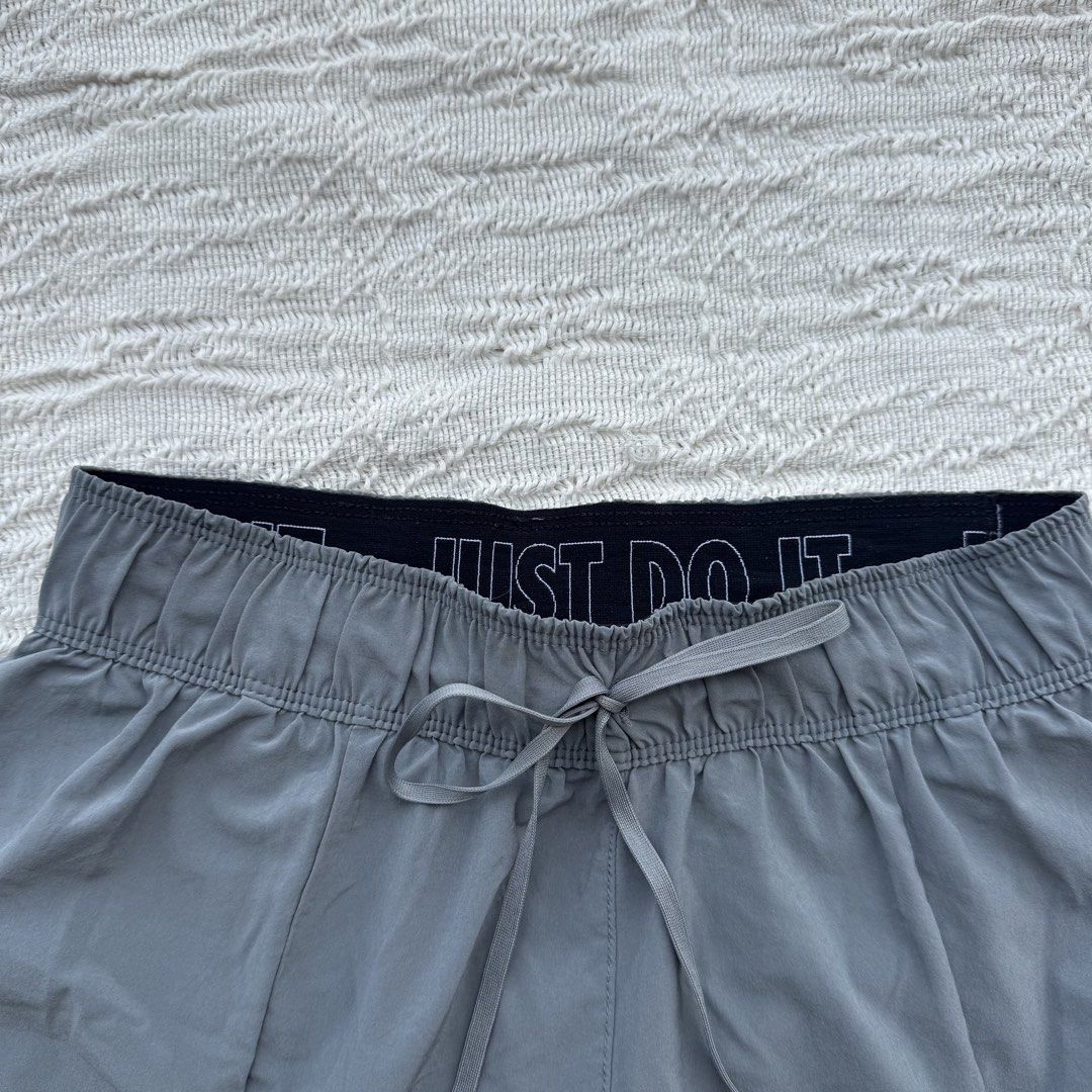 Nike Running Shorts Gray Flex Essential (Category: Activewear) located in Manila. Submitted by thriftclub.ph (Listing ID 1466097105, Image 2). Description: ▫️Decluttering (too many sportswear!) ◻️ Fits xs - s ⬜️ Has drawstring + 1 side pocket (cycling) ⚪️ Flaw: Portion of logo got removed ⬜️ In good condition ◻️ Perfect for running ▫️With “Just Do It” written in garter.