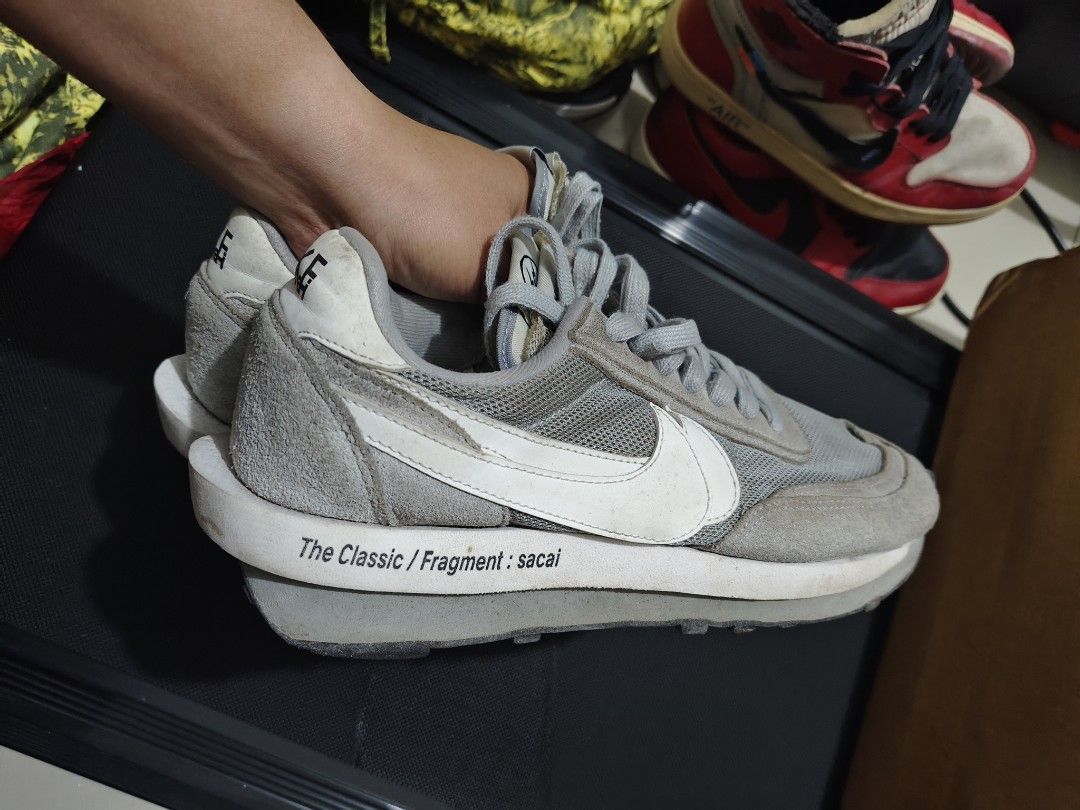 Nike Sacai Fragment Grey (Category: Sneakers) located in Manila. Submitted by vicious1419 (Listing ID 1465975976, Image 2). Description: EURO 42.5 - Model: Nike LDWaffle x sacai x Fragment - Colorway: Grey and White - Design Details: Double-stacked swooshes, Fragment midsole text, waffle outsole, dual branding tongue tags - Materials: Premium suede overlays with breathable mesh base - Condition: Shows dirt and wear on outsoles and midsoles from p