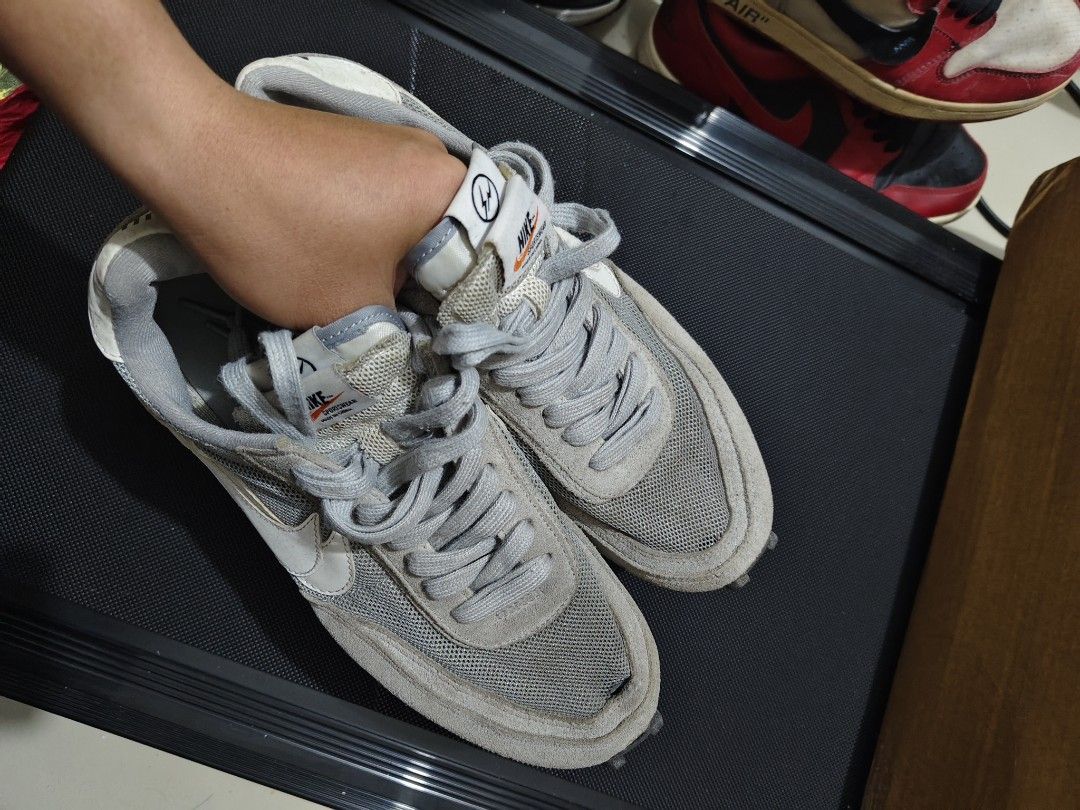 Nike Sacai Fragment Grey (Category: Sneakers) located in Manila. Submitted by vicious1419 (Listing ID 1465975976, Image 1). Description: EURO 42.5 - Model: Nike LDWaffle x sacai x Fragment - Colorway: Grey and White - Design Details: Double-stacked swooshes, Fragment midsole text, waffle outsole, dual branding tongue tags - Materials: Premium suede overlays with breathable mesh base - Condition: Shows dirt and wear on outsoles and midsoles from p