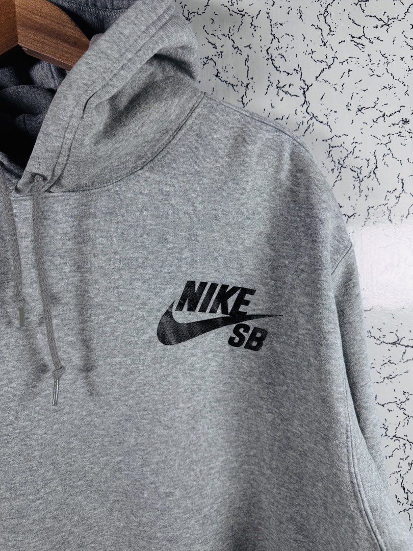 Nike SB Heather Grey Pullover Hoodie Size XL (Category: Hoodies) located in Roxas City. Submitted by patsquarephantz (Listing ID 1466088604, Image 2). Description: - Brand: Nike SB - Style: Pullover Hoodie - Color: Classic Heather Grey - Size: XL - Details: Black Nike SB logo on chest, adjustable drawstring hood, front kangaroo pocket - Condition: Noticeable discoloration and stains near the bottom pocket area (priced accordingly).