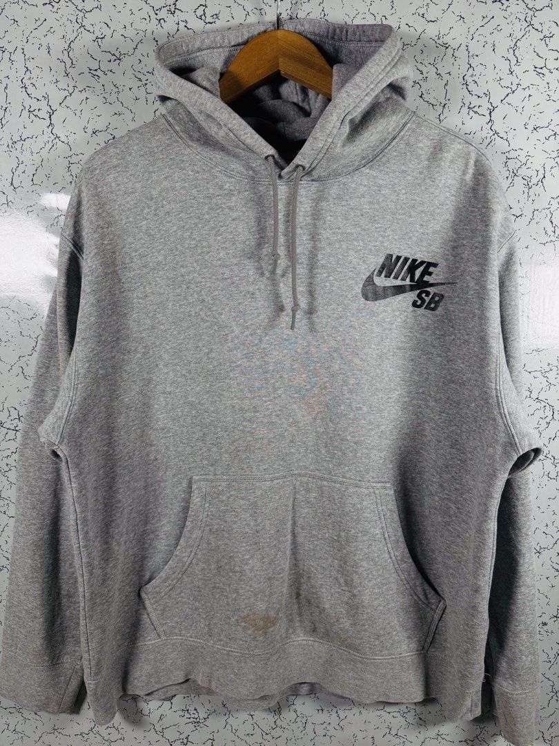 Nike SB Heather Grey Pullover Hoodie Size XL (Category: Hoodies) located in Roxas City. Submitted by patsquarephantz (Listing ID 1466088604, Image 1). Description: - Brand: Nike SB - Style: Pullover Hoodie - Color: Classic Heather Grey - Size: XL - Details: Black Nike SB logo on chest, adjustable drawstring hood, front kangaroo pocket - Condition: Noticeable discoloration and stains near the bottom pocket area (priced accordingly).